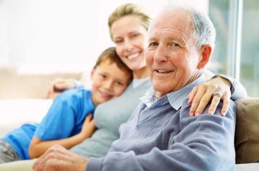 Elderly gentleman visiting with family in Reflections Memory Care in Phoenix