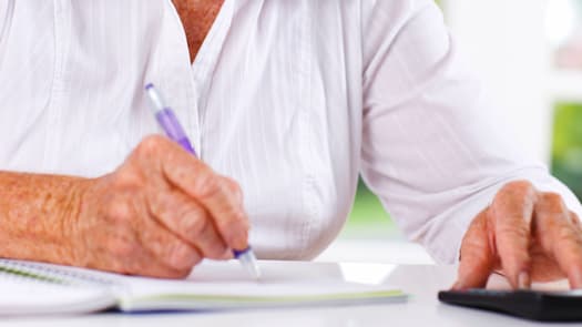 person writing on notebook