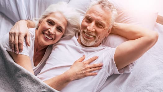 smiling couple in a bed