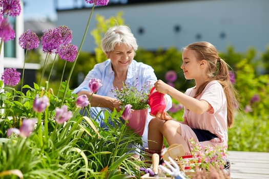 elder person and child gardening together