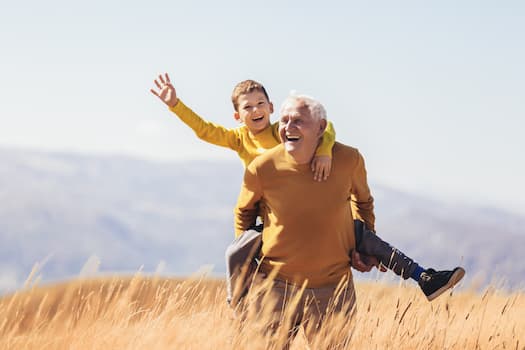 man with child riding on his back