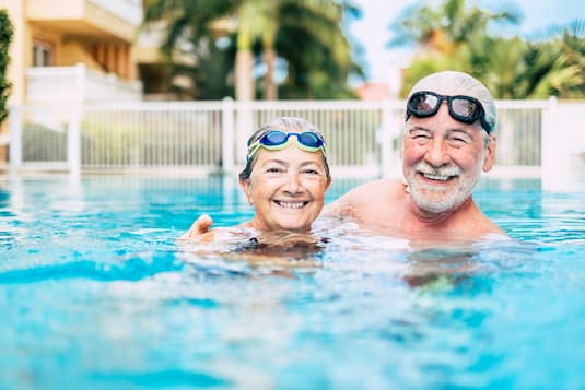 2 people swimming in a pool