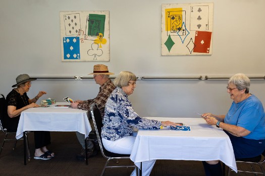 Friends playing cards at Fellowship Square independent living in Tucson